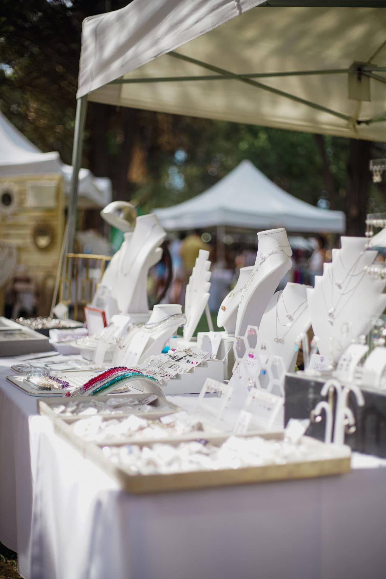 Handmade jewellery displayed on a market stall table